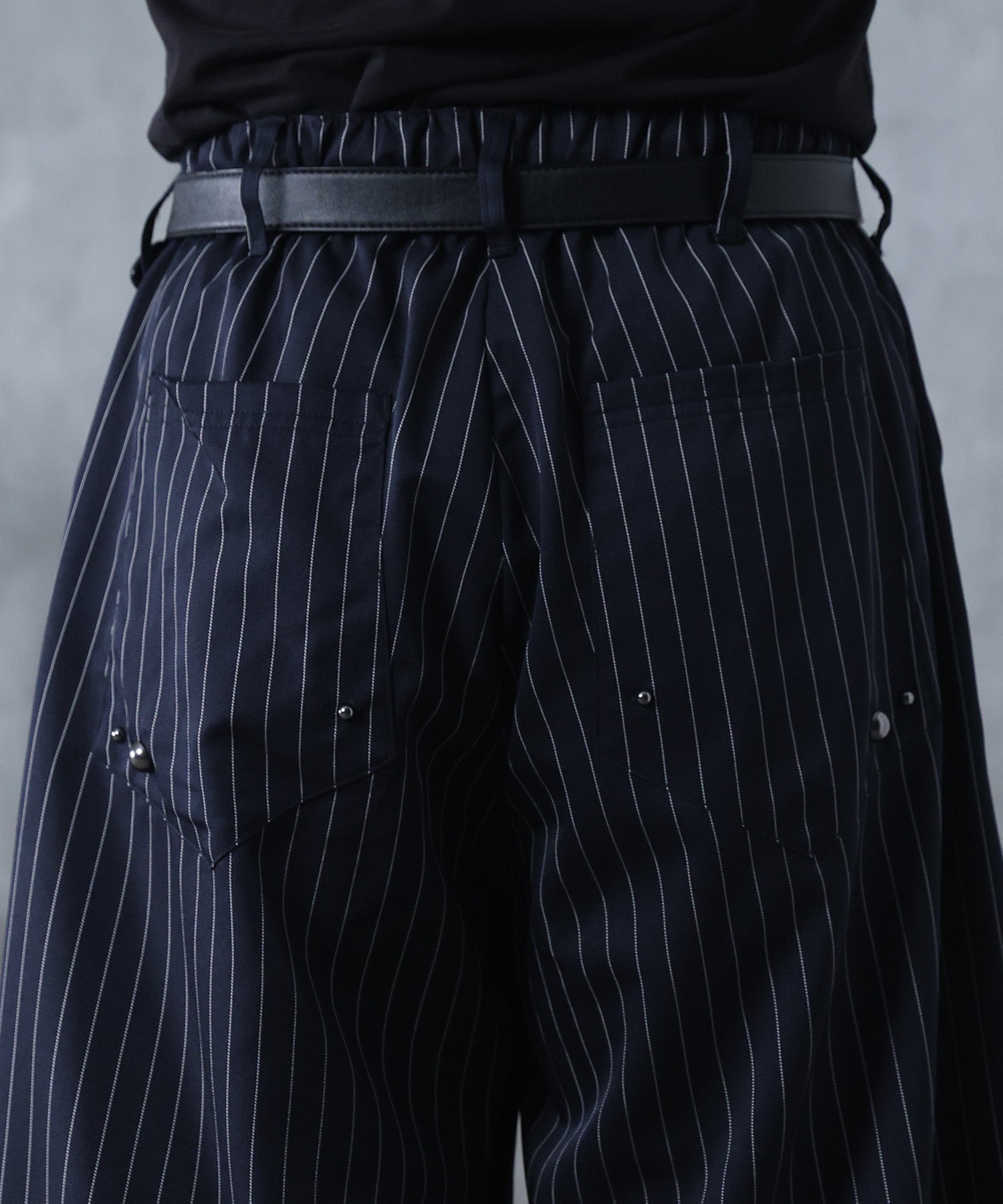 スラックス スタッズ カーブパンツ